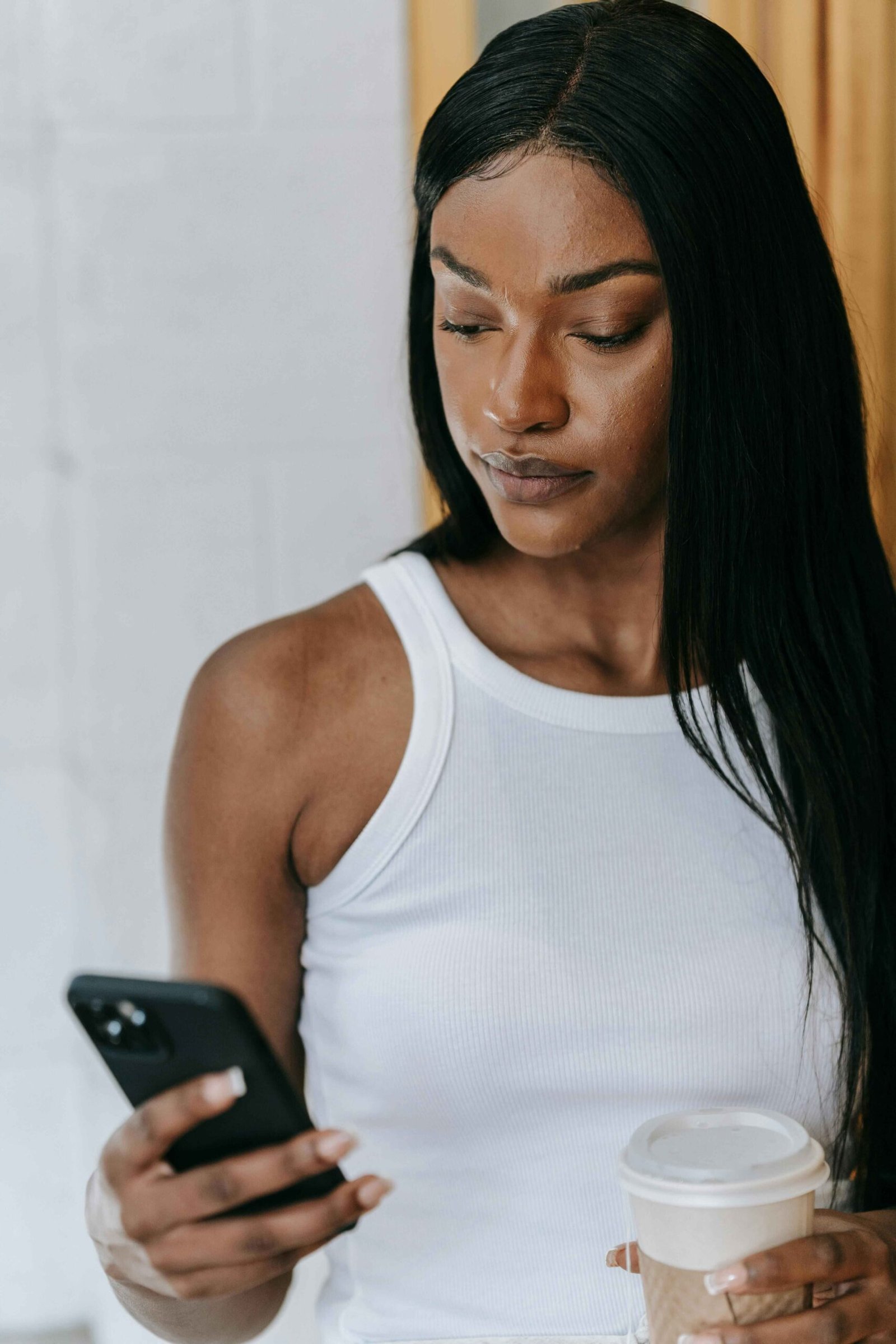 Woman holding her phone, deep in thought