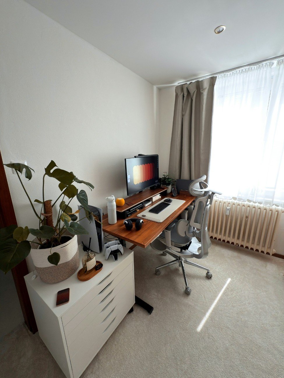 Bright minimalist workspace with a standing desk and laptop